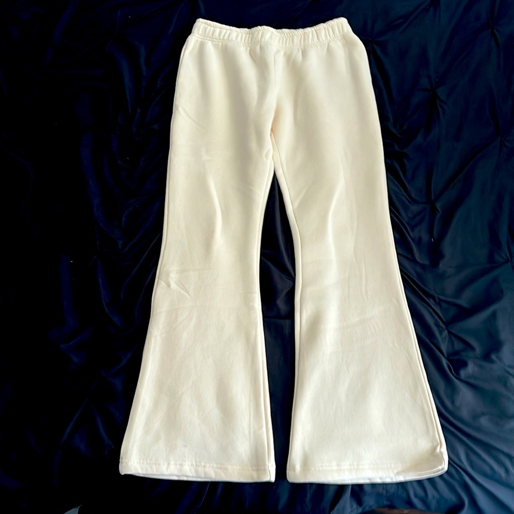 Soft, cream colored flared sweatpants, brand new, with warm fuzz inside.